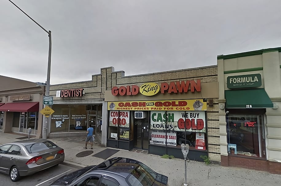 King Gold and Pawn shop at 24 W Merrick Rd in Freeport, NY. Brick shop front with large windows and a "cash for gold" sign.