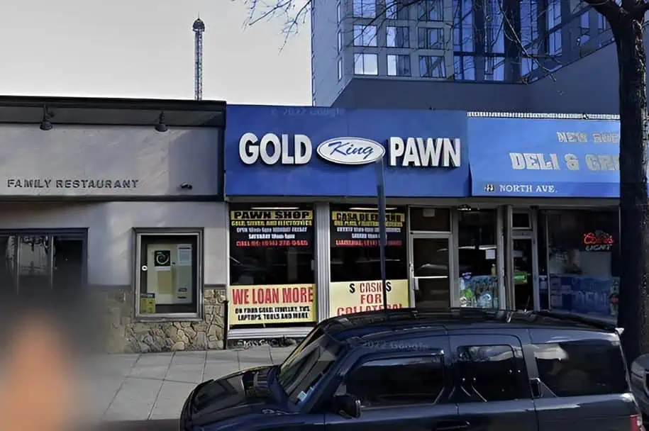 King Gold and Pawn shop at 217 North Ave in New Rochelle, NY. Pawn shop store front with a blue awning and large windows.