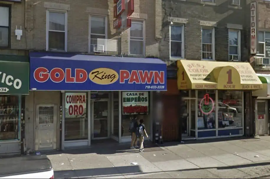 King Gold and Pawn shop at 4507 5th Ave in Brooklyn, NY. Pawn shop store front with a blue awning and large windows.